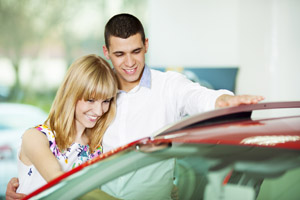 Couple looking at new car